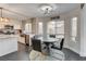 Dining area adjacent to the modern kitchen with a round table and backyard view at 8636 Caribbean Ct, Las Vegas, NV 89117
