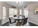 Cozy dining area with a round table, modern chairs, natural light, and backyard view at 8636 Caribbean Ct, Las Vegas, NV 89117