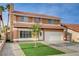 Two story home with terra cotta roof, grassy lawn, small tree and desert landscaping at 8636 Caribbean Ct, Las Vegas, NV 89117
