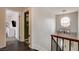 Upstairs hallway featuring wood floors and a modern light fixture at 8636 Caribbean Ct, Las Vegas, NV 89117