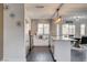 Modern kitchen with stainless steel appliances, white cabinetry, and a center island with a marble countertop at 8636 Caribbean Ct, Las Vegas, NV 89117