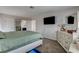 Large bedroom with a bed, dresser, and access to a bathroom at 8636 Caribbean Ct, Las Vegas, NV 89117