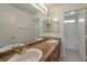 Bright bathroom features a double sink vanity with granite counters and updated fixtures at 91 Bowler Springs St, Las Vegas, NV 89148