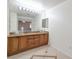 Bathroom featuring double vanity sinks, granite countertop, and modern lighting fixtures at 91 Bowler Springs St, Las Vegas, NV 89148
