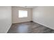 A cozy bedroom featuring laminate wood flooring and a window view at 91 Bowler Springs St, Las Vegas, NV 89148
