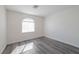 This bedroom features new gray wood flooring and a modern, updated window at 91 Bowler Springs St, Las Vegas, NV 89148