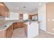 A bright kitchen with granite countertops, wood cabinets, and stainless steel appliances at 91 Bowler Springs St, Las Vegas, NV 89148