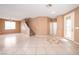 Open living space with tile floors, staircase, and a decorative glass front door at 91 Bowler Springs St, Las Vegas, NV 89148