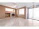 Bright living room showcasing neutral tones, a modern fireplace and glass doors to the backyard at 91 Bowler Springs St, Las Vegas, NV 89148