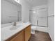 Bathroom featuring a wood vanity, a walk-in shower, and a toilet at 913 Boulder Springs Dr # 202, Las Vegas, NV 89128