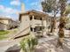 Exterior image of the home showing the stucco exterior, front walkway, and well-maintained landscaping at 913 Boulder Springs Dr # 202, Las Vegas, NV 89128