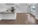 Bright kitchen features a breakfast bar, white cabinets, stainless steel appliances, and hard flooring at 913 Boulder Springs Dr # 202, Las Vegas, NV 89128