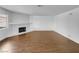 Empty living room features hard flooring, a fireplace and mantle, and natural light at 913 Boulder Springs Dr # 202, Las Vegas, NV 89128