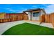 A covered porch with natural wood floors and gravel landscaping complements a yard of green artificial turf at 974 Balzar Ave, Las Vegas, NV 89106