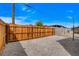 Fenced backyard with gravel ground cover and a clear blue sky overhead at 974 Balzar Ave, Las Vegas, NV 89106