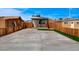 Expansive backyard featuring a concrete driveway and a patch of green artificial grass at 974 Balzar Ave, Las Vegas, NV 89106