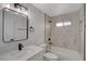 Well-lit bathroom featuring sleek vanity with black hardware, tub, and shower combination at 974 Balzar Ave, Las Vegas, NV 89106
