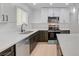 Well-lit kitchen featuring white quartz countertops and stainless steel appliances at 974 Balzar Ave, Las Vegas, NV 89106