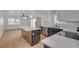 Open kitchen with island, stainless steel appliances, and a view into the living area at 974 Balzar Ave, Las Vegas, NV 89106