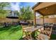 Spacious backyard with outdoor dining, hot tub, and seating areas, ideal for outdoor relaxation and activities at 9921 Rams Leap Ave, Las Vegas, NV 89166