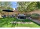 Landscaped backyard with hot tub, dining and lounging areas perfect for relaxation or entertaining guests at 9921 Rams Leap Ave, Las Vegas, NV 89166