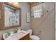 Bathroom featuring framed mirror over wood vanity and updated fixtures at 9921 Rams Leap Ave, Las Vegas, NV 89166