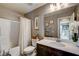 Bathroom with shower-tub combo, neutral walls, and vanity with dark wood cabinets at 9921 Rams Leap Ave, Las Vegas, NV 89166