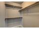 Walk-in closet featuring built-in wooden shelving to maximize storage and organization at 9921 Rams Leap Ave, Las Vegas, NV 89166