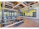 Bright gym featuring Pilates machines, wood floors, mirrored wall, and recessed ceiling lights at 9921 Rams Leap Ave, Las Vegas, NV 89166
