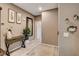 Welcoming hallway featuring stylish decor and light wood-look floors, and a decorative console table at 9921 Rams Leap Ave, Las Vegas, NV 89166