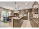 Modern kitchen with stainless steel appliances, granite countertops, and a center island at 9921 Rams Leap Ave, Las Vegas, NV 89166