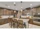 Modern kitchen featuring granite countertops, stainless steel appliances, and island with seating at 9921 Rams Leap Ave, Las Vegas, NV 89166