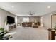 Large living room features a comfortable sectional sofa, ceiling fan, and plenty of natural light at 9921 Rams Leap Ave, Las Vegas, NV 89166