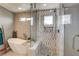 Modern bathroom features a glass enclosed shower with stylish tile work and a free-standing soaking tub at 9921 Rams Leap Ave, Las Vegas, NV 89166