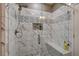 Walk-in shower featuring decorative tile, a built-in bench, and modern fixtures at 9921 Rams Leap Ave, Las Vegas, NV 89166