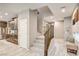 Entryway with staircase, light wood flooring, and access to the modern kitchen at 9921 Rams Leap Ave, Las Vegas, NV 89166