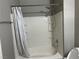 Bright bathroom with a shower and bathtub combination and a white shower curtain at , Las Vegas, NV 89148
