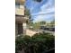 A building exterior is framed by lush greenery with a view of covered parking at , Las Vegas, NV 89148