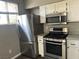 This kitchen has stainless steel appliances and white cabinets at , Las Vegas, NV 89148