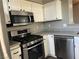 This kitchen has stainless steel appliances, white cabinets and gray countertops at , Las Vegas, NV 89148