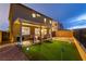 An outdoor oasis with putting green, covered patio, and modern seating for entertaining at 10372 Thurso Ave, Las Vegas, NV 89166