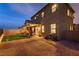 Backyard with putting green and covered patio at dusk at 10372 Thurso Ave, Las Vegas, NV 89166