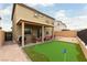 Home's backyard with putting green and covered patio, perfect for outdoor activities at 10372 Thurso Ave, Las Vegas, NV 89166