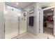Modern bathroom featuring a glass-enclosed shower and walk-in closet at 10372 Thurso Ave, Las Vegas, NV 89166