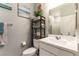 Cozy bathroom with vanity, toilet, and decorative shelving at 10372 Thurso Ave, Las Vegas, NV 89166
