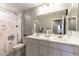 Bright bathroom featuring double sinks, ample counter space, and a shower with a curtain at 10372 Thurso Ave, Las Vegas, NV 89166