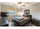 Comfortable bedroom with a ceiling fan and a window offering natural light at 10372 Thurso Ave, Las Vegas, NV 89166