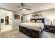 Comfortable bedroom featuring carpet floors, ceiling fan, and ensuite bathroom at 10372 Thurso Ave, Las Vegas, NV 89166