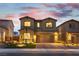 Charming two-story home with manicured front yard, brick driveway, and exterior lighting at 10372 Thurso Ave, Las Vegas, NV 89166
