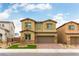 Two-story home with a brick driveway, lush green lawn, and a welcoming facade under a clear blue sky at 10372 Thurso Ave, Las Vegas, NV 89166